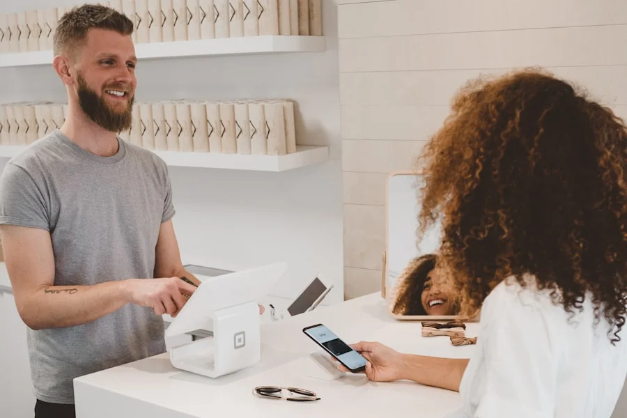 Person holding a credit card over a wooden table
